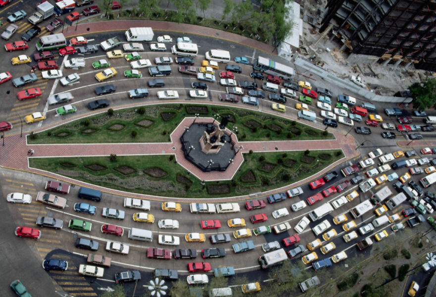 Aerial view of heavy traffic congestion around a roundabout in one of the cities with the worst traffic in the world.