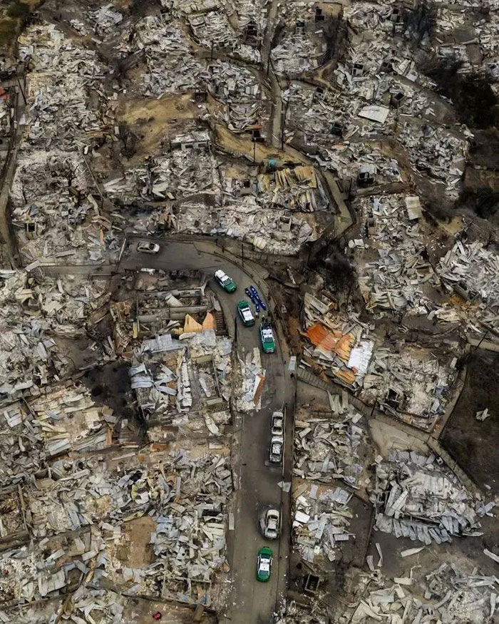 Aerial view of Chile town showing destruction and chaos after wildfires burned most buildings overnight.
