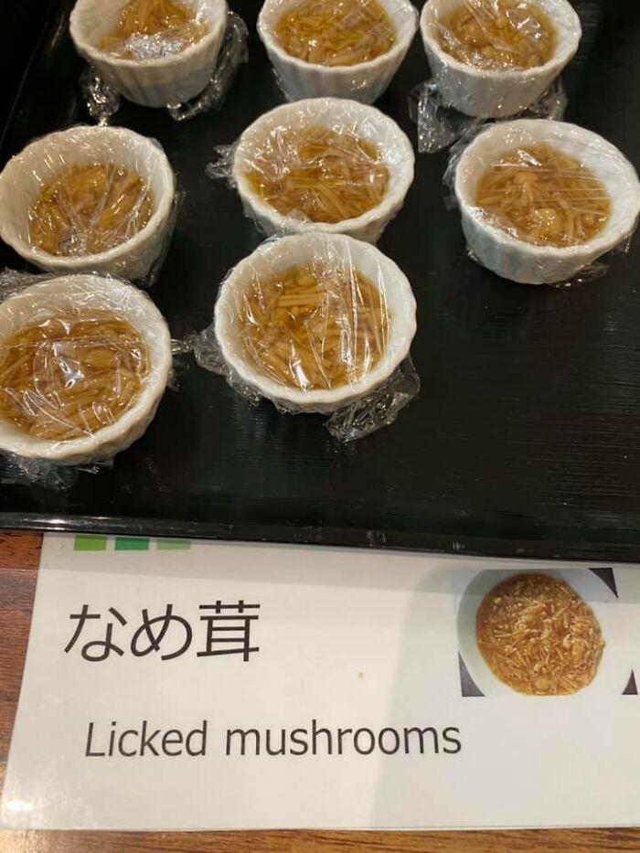 Small cups of mushrooms covered in plastic wrap labeled with a funny Japan English translation error for SEO keywords.