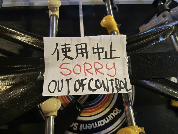 Handwritten sign with Japanese characters and English translation saying sorry out of control, showing Japan translation errors.