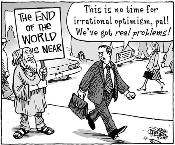 Cartoon by Dan Piraro showing a man with a sign about the end of the world and another man discussing real problems.