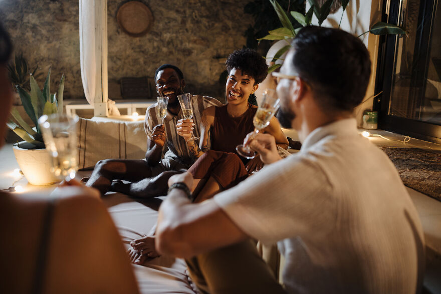 Friends enjoying drinks and laughter during a relaxed gathering, sharing fun moments and paranoia questions together. Friends enjoying drinks and laughter during a relaxed gathering, sharing fun moments and paranoia questions together.