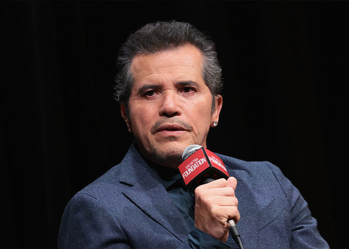 Star actor speaking into a microphone, addressing fans amid controversy involving ICE and public backlash.