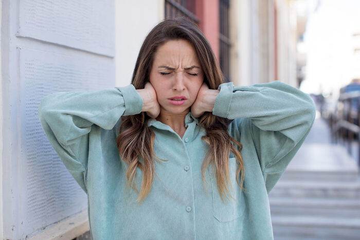 Young woman with eyes closed holding her neck in discomfort, illustrating moments people realize something is not normal.