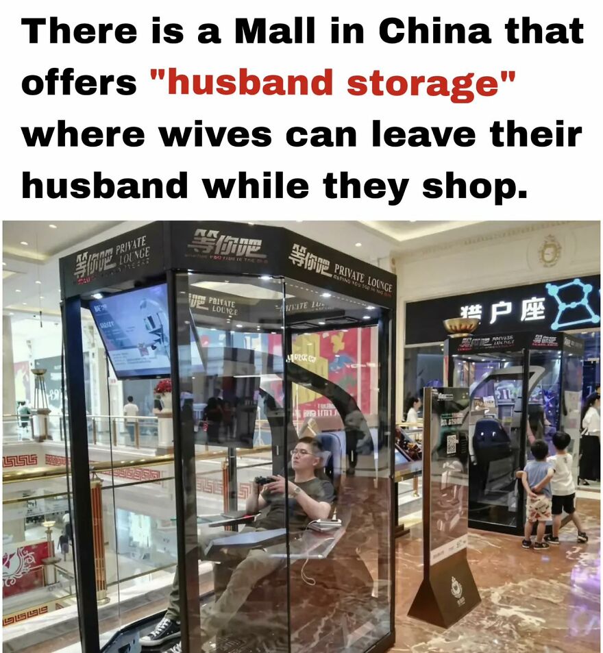 Man playing video games inside glass “husband storage” booth in a busy mall, relatable meme for exhausted adults.