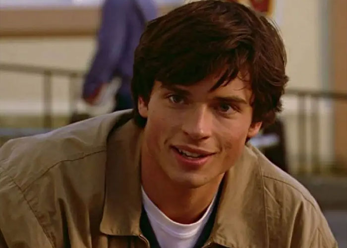 Young man with dark hair wearing a tan jacket smiling, representing 2000s teen heartthrob appearance at 48. Young man with dark hair wearing a tan jacket smiling, representing 2000s teen heartthrob appearance at 48.