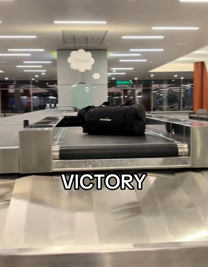 Baggage claim carousel with black duffel bag and underwear appearing one by one during passenger's viral moment. Baggage claim carousel with black duffel bag and underwear appearing one by one during passenger's viral moment.