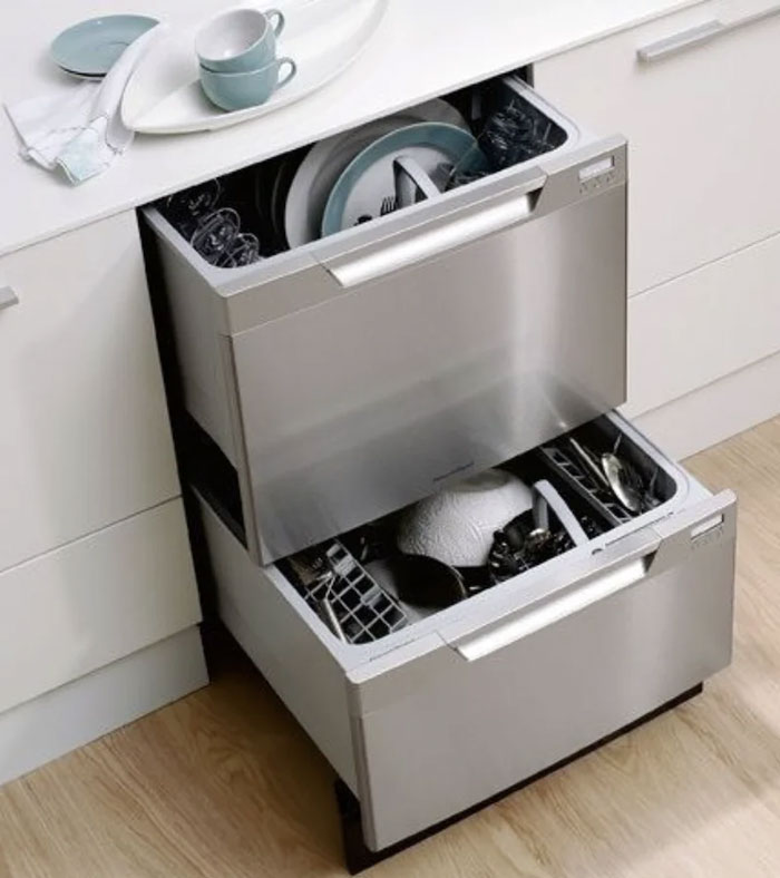 Double drawer dishwasher in a modern kitchen, showcasing unique household items from different countries.