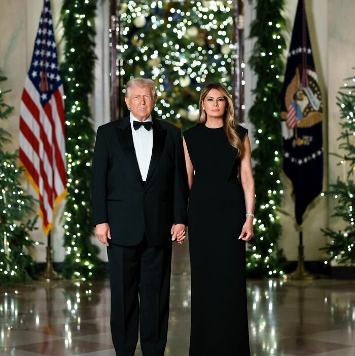 Melania Trump and Donald Trump dressed formally at Mar-a-Lago with festive holiday decorations in the background. Melania Trump and Donald Trump dressed formally at Mar-a-Lago with festive holiday decorations in the background.