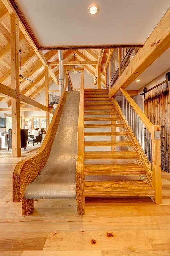 Wooden staircase with a built-in slide in a spacious room showcasing beautifully crafted woodworking projects.