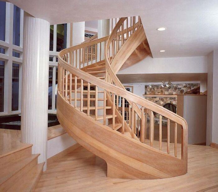 Spiral wooden staircase showcasing beautifully crafted woodworking projects with smooth curves and elegant design.