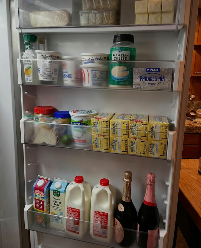 Open refrigerator door showing various dairy products and beverages during controversial Melissa Gilbert Instagram fridge tour.