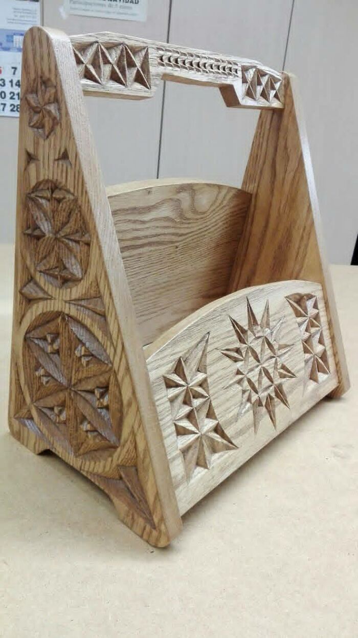 Handcrafted woodworking project featuring intricate carved star and geometric patterns on a wooden toolbox.