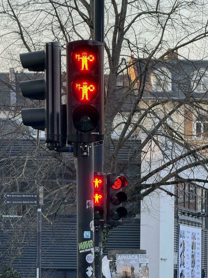 Traffic lights featuring unique red pedestrian signals with a creative design, showcasing impressive things countries implemented.