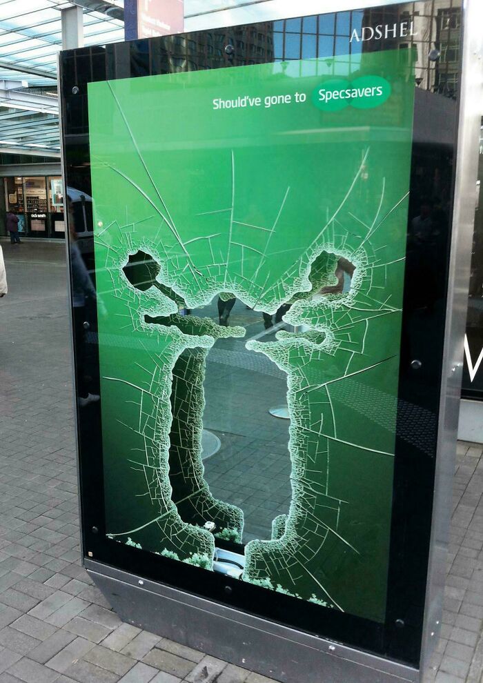 Creative print advertisement with humor shows shattered glass forming two people arguing, highlighting competitor comparison.