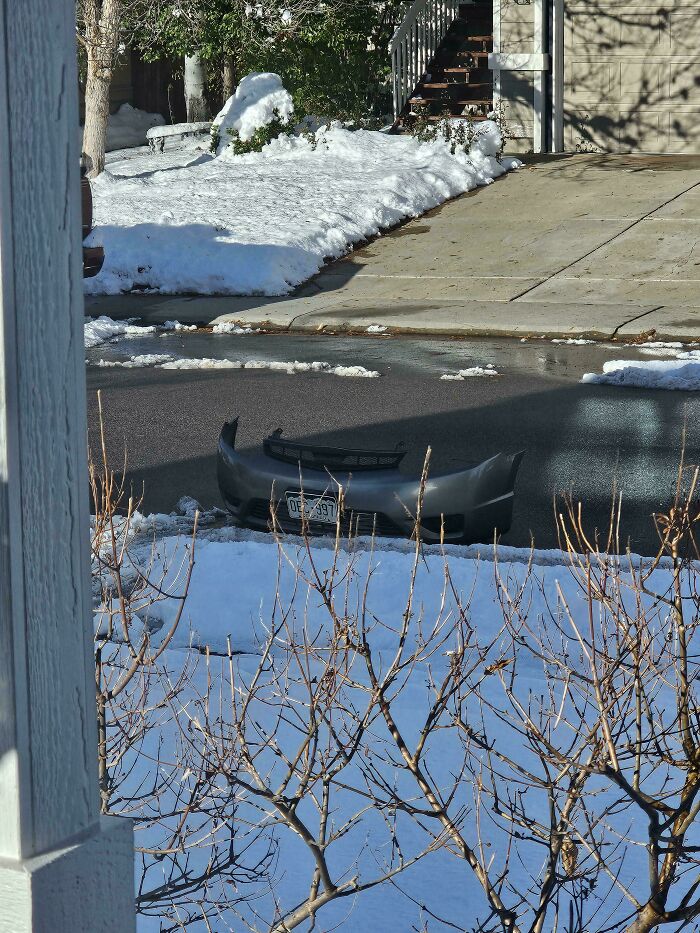 Car bumper stranded in a snowy neighborhood street, a real-life Glitches in the Matrix moment