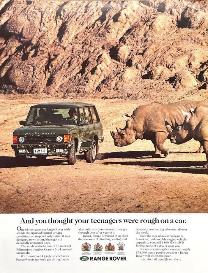Range Rover print advertisement using humor and creativity featuring a rugged vehicle facing rhinos in a desert landscape.