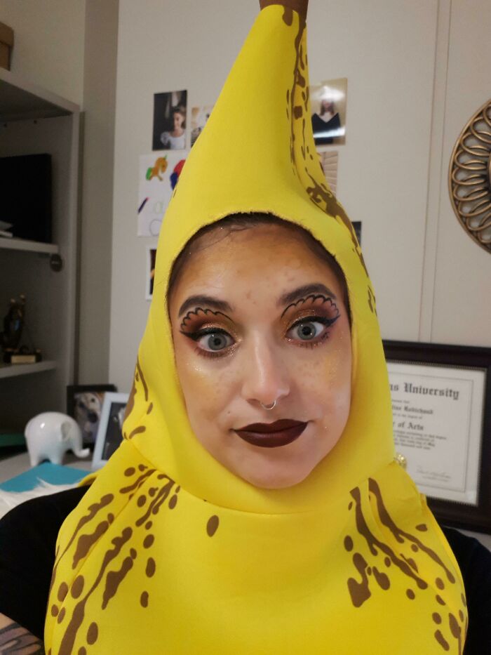 Person in banana costume with dramatic eye makeup and surprised expression, woke up expecting