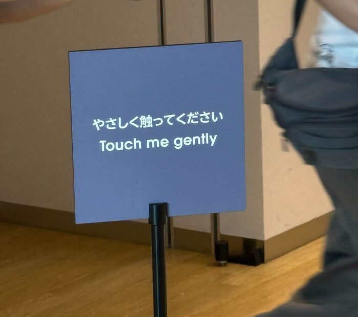 Sign in Japanese and English saying Touch me gently, illustrating Japan getting lost in translation to English humor.