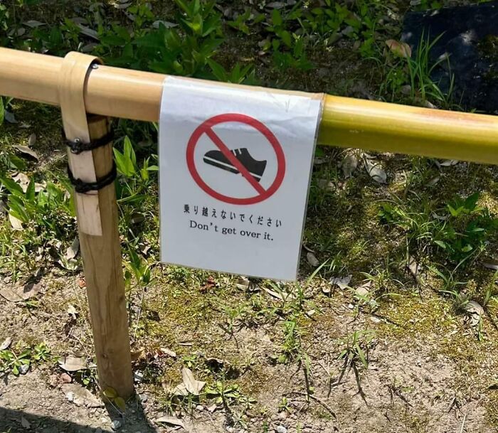 Sign in Japan with humorous English translation saying Dont get over it, showing Japan getting lost while translating to English.