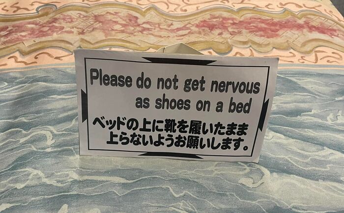 Sign with humorous English translation errors from Japan warning against wearing shoes on the bed, illustrating translation mistakes.