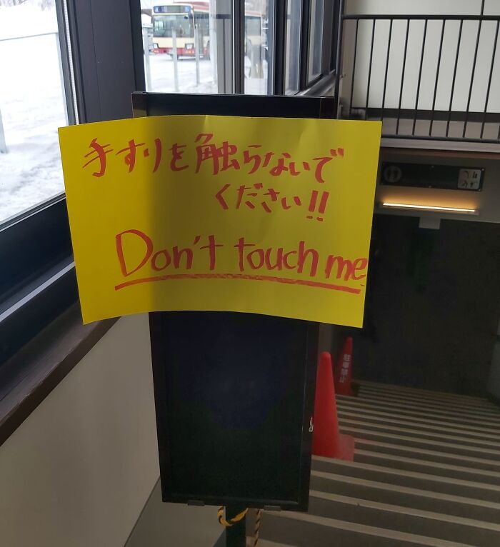 Yellow sign with mistranslated English text saying Don't touch me, illustrating hilarious Japan translation errors.