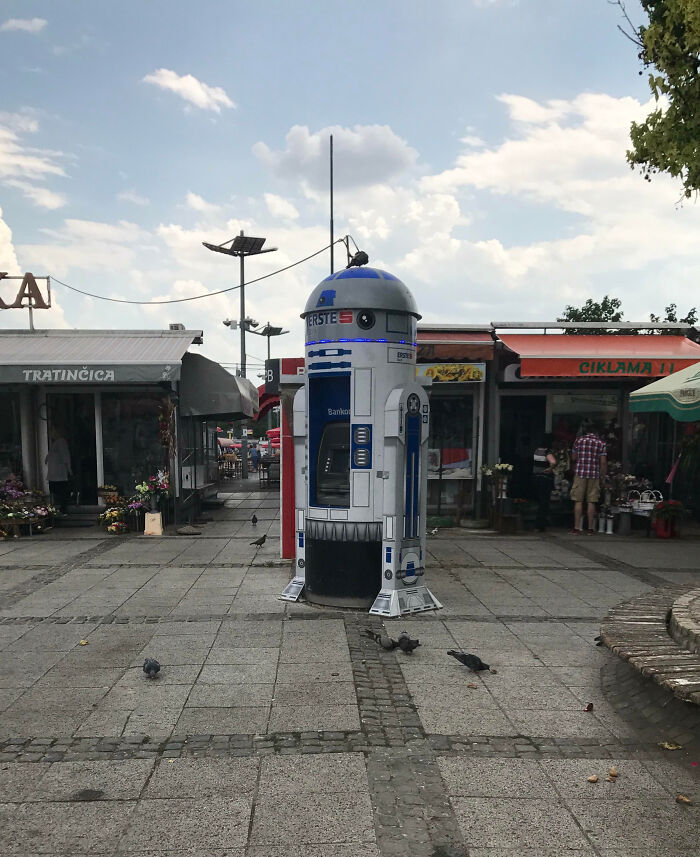 R2-D2 designed public trash bin in a town square, showcasing impressive things countries implemented for public use.