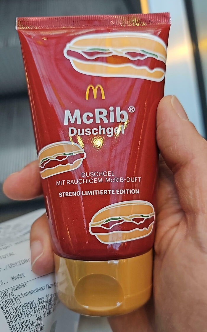 Hand holding a limited edition McRib scented shower gel tube, showcasing an impressive country product implementation.