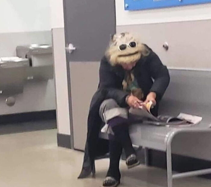 Person wearing an unusual mask and sunglasses sitting on a bench, creating one of the confusing pictures that are funny moments.