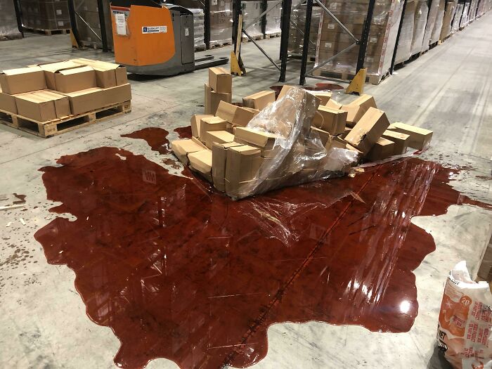 Warehouse scene showing a large spill and damaged boxes, illustrating unfortunate and expensive fails in storage operations.