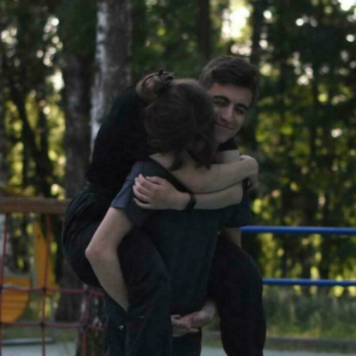 Two people embracing in a park setting, illustrating unhinged moments that went from 0 to 100 unexpectedly.