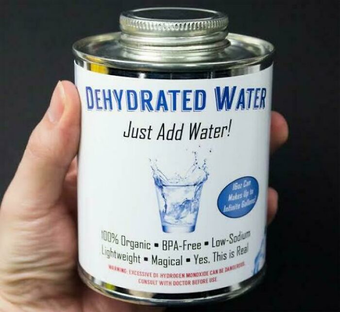 Hand holding a can labeled dehydrated water with humorous text just add water and magical properties.