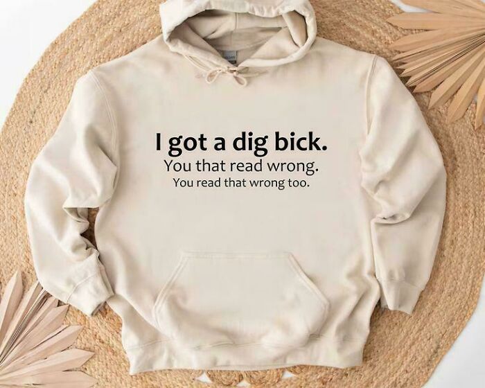 Beige hoodie with humorous text causing a double-take, showcasing unhinged images that catch people off-guard.