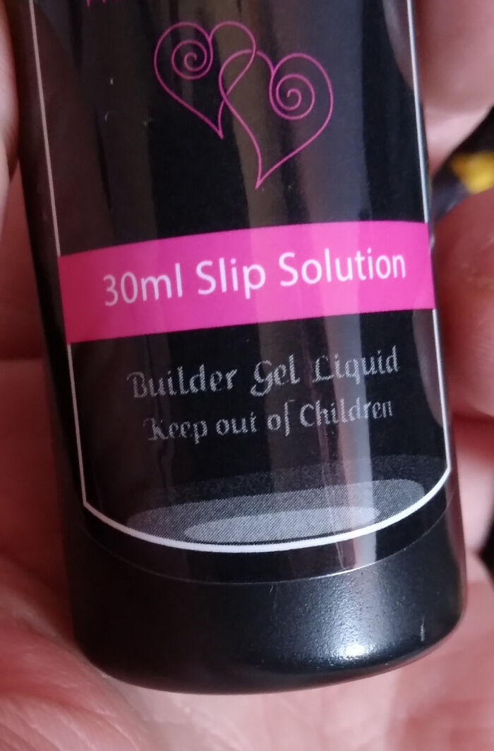 Close-up of a 30ml slip solution bottle labeled builder gel liquid with warning to keep out of children’s reach.