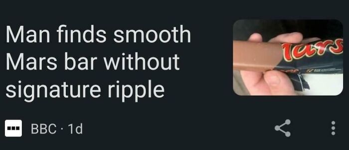 Hand holding a smooth Mars bar without signature ripple, illustrating a wild incident hard to believe from news headlines.