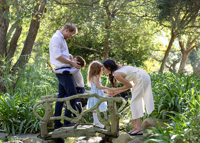 Family moment on a small bridge in a lush garden, highlighting Meghan Markle’s alleged rift with mom Doria theories. Family moment on a small bridge in a lush garden, highlighting Meghan Markle’s alleged rift with mom Doria theories.