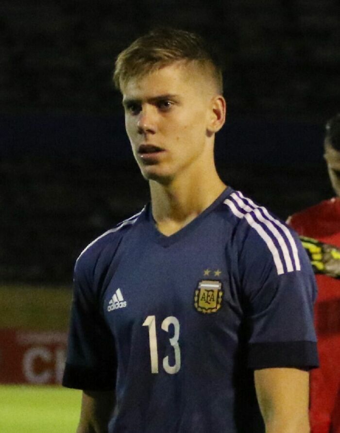Juan Foyth wearing Argentina national team jersey during a football match, focused and ready to play on the field.