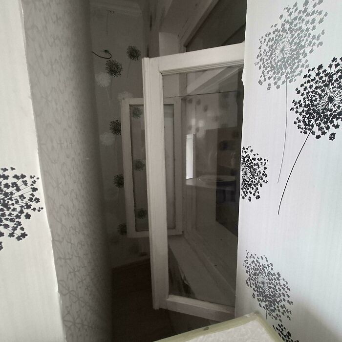 Narrow hallway with multiple open windows causing a problematic design decision by designers nobody asked for.