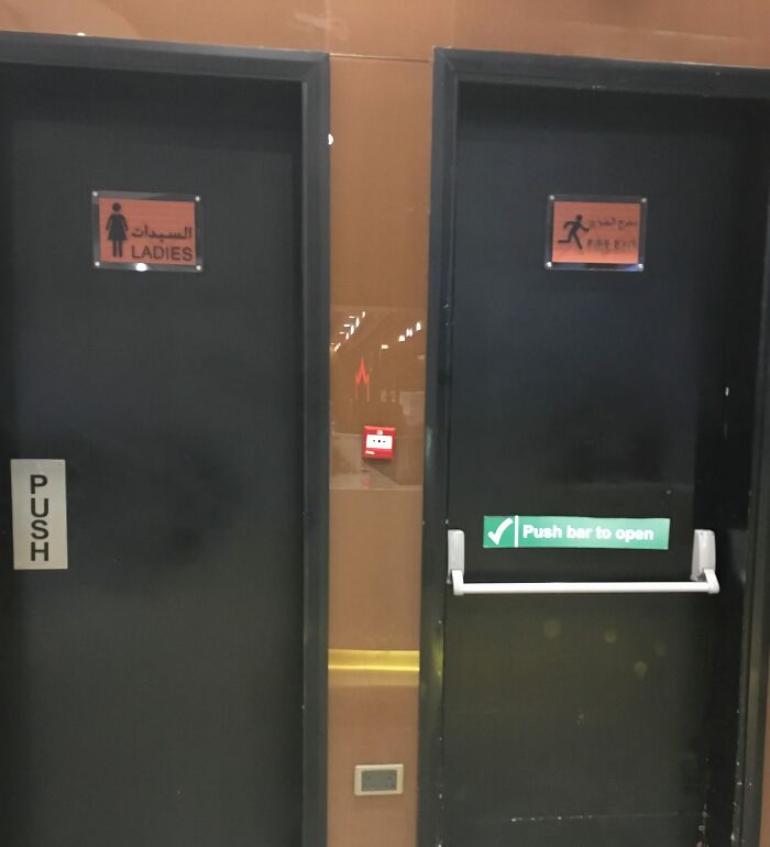 Two different doors side by side showing poor designer decisions creating problems nobody asked for in signage.