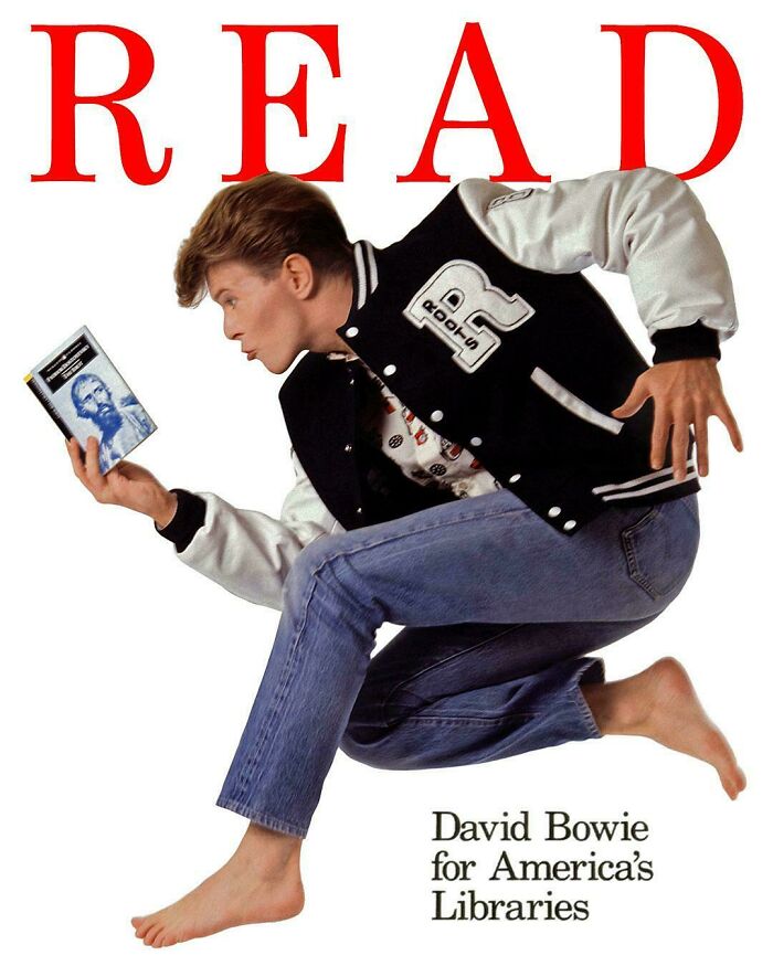 David Bowie in a vintage advertisement promoting reading for America's libraries, jumping and holding a book.
