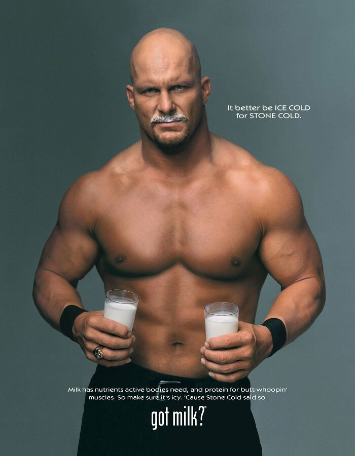 Muscular man holding two glasses of milk in a vintage advertisement promoting milk nutrients and protein benefits.