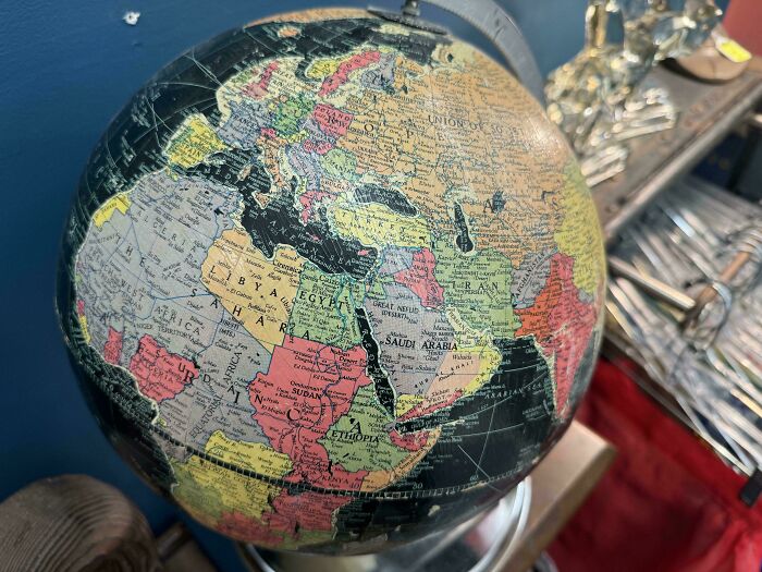 Close-up of a vintage globe highlighting Europe and surrounding regions, illustrating normal practices in Europe versus the US.