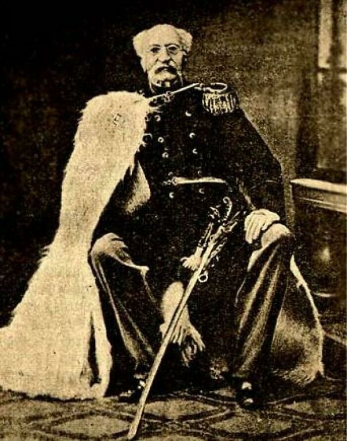 Vintage sepia-toned portrait of a man in military attire, reflecting unsettling history and crime themes.