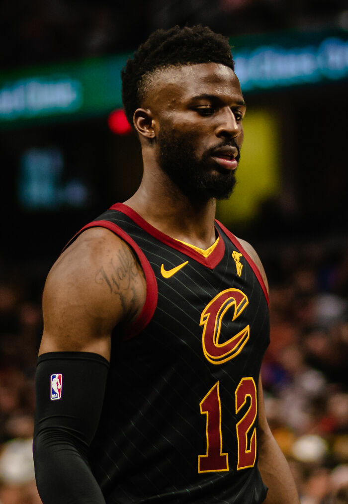 David Nwaba in a Cleveland Cavaliers basketball jersey during a game, showing focus and determination on the court.