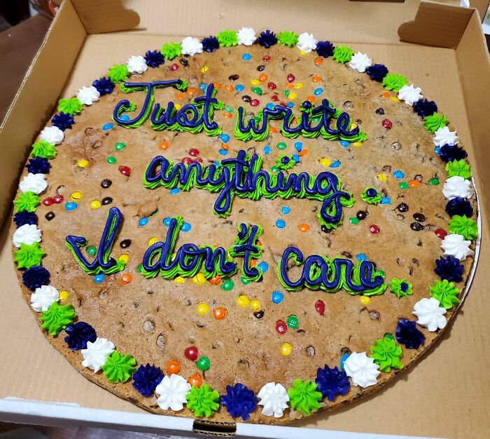 Large cookie cake decorated with colorful icing and candy, featuring a humorous message reflecting honest emotions.