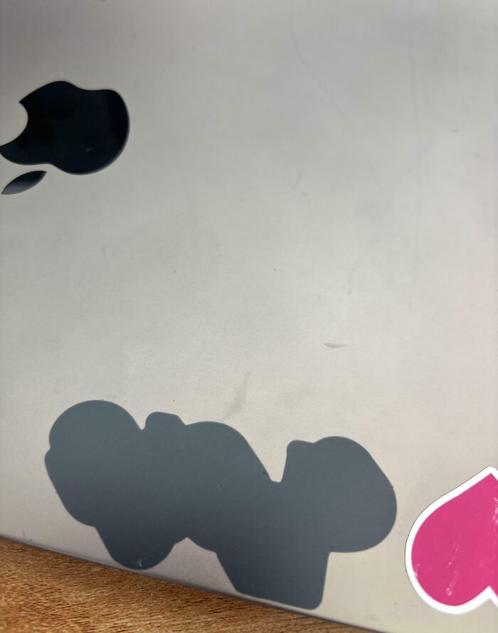 Worn down Apple logo sticker on a laptop showcasing everyday objects deteriorating in unexpected ways.