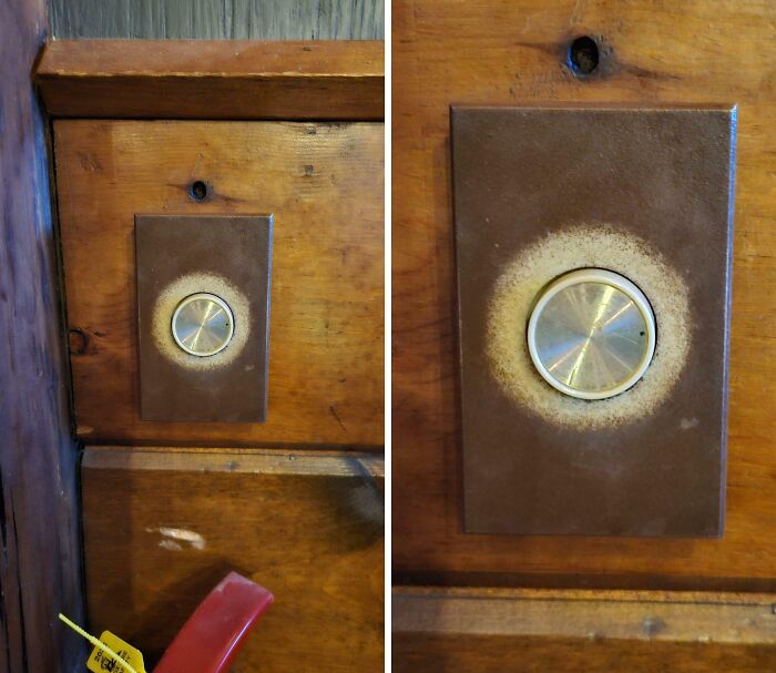 Close-up of a worn-down metal k**b on aged wooden panel showing unexpected wear on everyday objects.