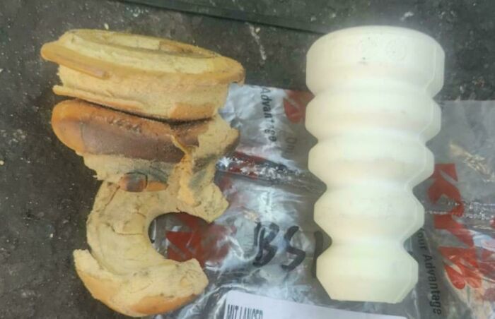 Worn down rubber car part compared to a new white replacement, showing everyday object wear in unexpected ways