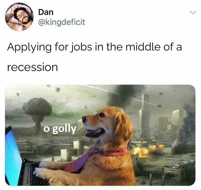 Dog in a tie using laptop with explosions in the background illustrating recruitment nightmares during a recession.