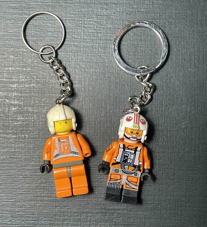 Worn down Star Wars LEGO keychains showing faded and scratched details on a dark textured surface.